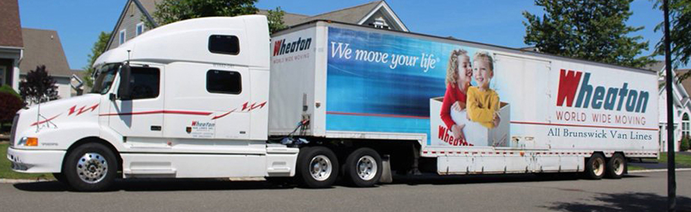 a wheaton worldwide moving truck in a residential area